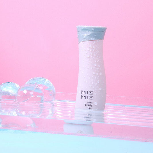 a glass vase with a pink rose in it