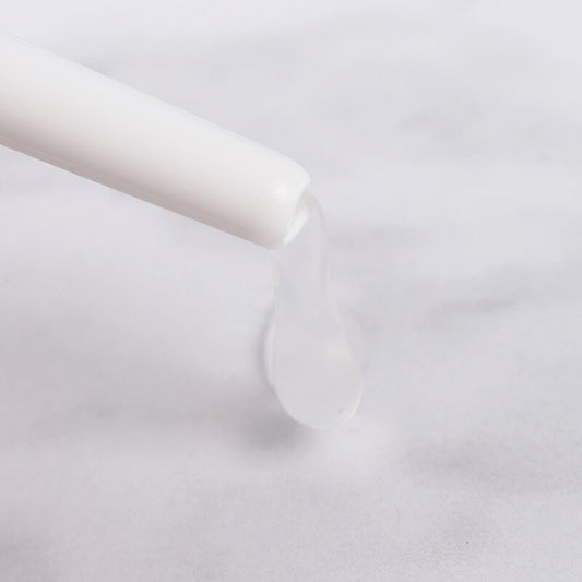 a white toothbrush is in a white glass