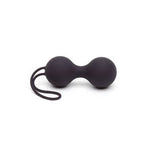 a pair of black scissors sitting on top of a table