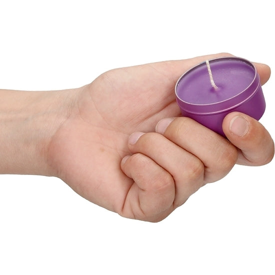 a person holding a purple toothbrush in their hand