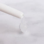 a white toothbrush is in a white glass 