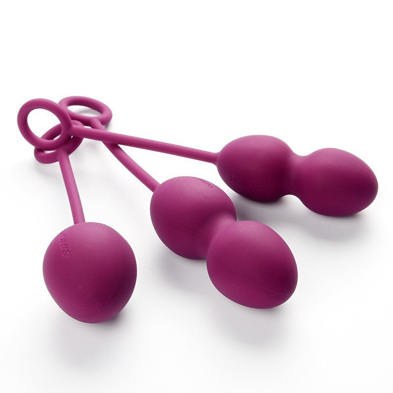 a pair of pink scissors on a white surface 