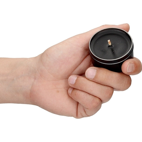 a person holding a black cell phone in their hand 